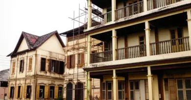 Architectural Styles and Symbolism: Traditional Lao Design, French Colonial Influences, Materials, and Restoration Practices